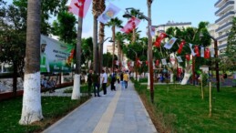 Tarsus Aznakay Parkı Yeni Konseptiyle Hizmete Açıldı   Tarsus Belediyesi Park ve Bahçeler Müdürlüğü tarafından kapsamlı bir revize çalışmasıyla modern bir görünüme kavuşturulan Aznakay Parkı, düzenlenen törenle yeniden halkın hizmetine açıldı.  Saat 17.00’de başlayan açılış törenine Tarsus Belediye Başkanı Ali Boltaç, belediye başkan yardımcıları, meclis üyeleri, birim müdürleri, mahalle muhtarları, basın mensupları, çok sayıda vatandaş ve çocuklar katıldı. Tarsus Belediyesi Bando Ekibi’nin eşliğinde gerçekleşen saygı duruşu ve İstiklal Marşı ile başlayan program, mahalle muhtarı Mustafa Naci Güllü’nün konuşmasıyla devam etti.  Muhtar Güllü, parkın bugünkü modern görünümüne kavuşmasında emeği geçenlere teşekkür ederek, “Bu park hepimizin. Burada yaşayan çocuklarımızın ve mahalle sakinlerimizin, bu güzel alanı koruma konusunda hassasiyet göstermesi çok önemli” ifadelerini kullandı.  Başkan Boltaç’tan Park ve Bahçeler Müdürlüğüne Teşekkür  Törende söz alan Tarsus Belediye Başkanı Ali Boltaç, Park ve Bahçeler Müdürlüğü personeline teşekkür ederek belediye çalışmaları hakkında bilgi verdi. Asfalt ve sathi kaplama çalışmalarının kent genelinde hız kesmeden devam ettiğini belirten Boltaç, parkların da modern ve kullanışlı bir yapıya dönüştürüldüğünü vurguladı.  Başkan Boltaç, ayrıca Tarsus AVM yanında yer alan ve 7 gün 24 saat hizmet verecek olan okuma salonuna ilişkin önemli bir açıklamada bulundu. CHP Grup Başkanvekili ve Mersin Milletvekili Ali Mahir Başarır’a bir söz verdiğini hatırlatan Boltaç, salonun yakın geçmişte hayatını kaybeden Sırrı Süreyya Önder’in adıyla hizmete açılacağını duyurdu.  Kurdele Çocuklarla Birlikte Kesildi  Konuşmaların ardından açılış kurdelesi Belediye Başkanı Ali Boltaç, belediye başkan yardımcıları, meclis üyeleri, mahalle muhtarları ve çocukların katılımıyla kesildi. Daha sonra katılımcılarla birlikte park gezilerek vatandaşların kullanımına sunuldu.  Başkan Boltaç, parkın Tarsuslulara hayırlı olmasını dileyerek, “Amacımız halkımıza nefes alabileceği, modern ve güvenli yaşam alanları sunmaktır” dedi.
